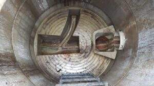 Sewer rehabilitation: View from above into manhole with two inlets and GRP channel